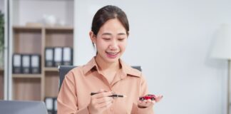 Asian businesswoman negotiates the sale of a car, discussing insurance and financing options