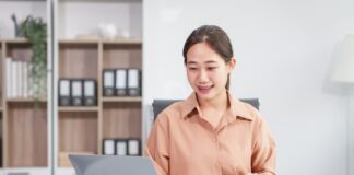 Asian businesswoman negotiates the sale of a car, discussing insurance and financing options