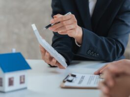 Happy couple signing a contract with real estate agent. renters tenants sign mortgage loan