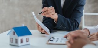 Happy couple signing a contract with real estate agent. renters tenants sign mortgage loan