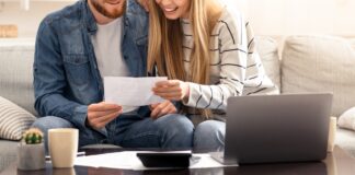 Happy married couple looking at personal finances at home