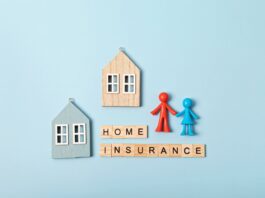 Home insurance message and wooden houses over blue background