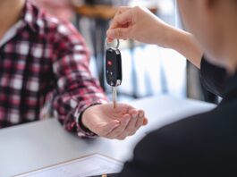 Insurance officers hand over the car keys after the tenant. have signed an auto insurance document o