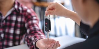 Insurance officers hand over the car keys after the tenant. have signed an auto insurance document o