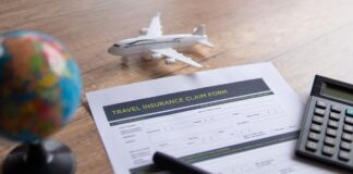 Selective focus image of travel insurance claim form on a wooden table.