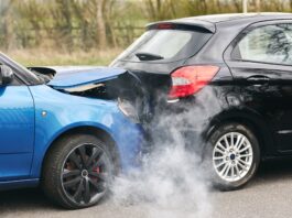 Two Damaged Cars Involved In Road Traffic Accident Showing Smoke After Collision